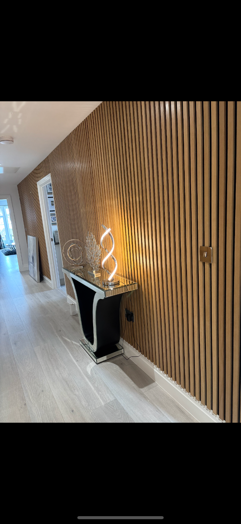 Oak slatted wall panelling in hallway
