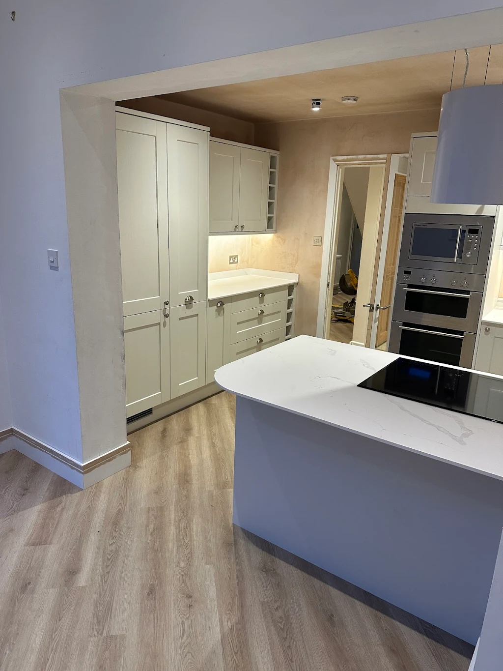Grey kitchen with island and oak floor